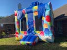 Perfect for Austin birthday parties, this colorful balloon-themed bounce house rental features a 13x13ft jumping area with slide