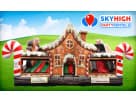 Perfect for Dallas holiday parties, this gingerbread bounce house rental features a slide and candy cane pillars for festive