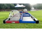 Dual-lane water slide rental in Houston with red, blue, and white sections, splash pool, and tent setup—ideal for large events