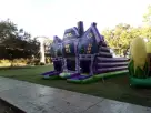 Purple and green haunted house maze bounce house rental in Austin, ideal for Halloween parties and Georgetown events.