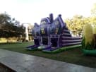 Purple and green haunted house maze bounce house rental in Austin, ideal for Halloween parties and Georgetown events.