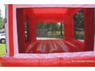 Red bounce house with pink trim and mesh windows available for rental in McKinney area celebrations.
