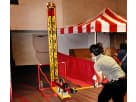 Red and white striped carnival tent rental in Houston with service window, ideal for Sugar Land parties.
