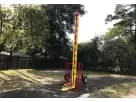 Yellow and red High Striker interactive game rental in Houston backyard with adjustable difficulty, ideal for League City events.