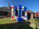 Colorful balloon-themed bounce house rental in Austin with 13x13ft jumping area, perfect for kids' birthday parties in Cedar Park.