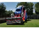 Patriotic monster truck bounce house rental in Houston backyard—18ft wet or dry slide, ideal for Kingwood parties.