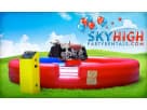 Red and yellow mechanical bull rental in Dallas with padded arena, ideal for events holding up to 30 riders per hour.
