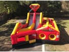 Fire truck bounce house rental in Houston with slide and obstacle course, ideal for The Woodlands parties.
