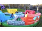 Colorful interactive obstacle course rental in Austin perfect for kids' parties, featuring climbing elements and log barriers