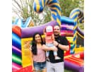 Colorful candy-themed toddler bounce house rental in Austin with slides and climbing elements, ideal for Pflugerville birthday
