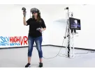 Woman demonstrating VR headset with motion controllers in Austin virtual reality rental package ideal for Pflugerville events.