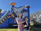 Space-themed bounce house rental in Houston with dual slides, perfect for 6-8 kids at backyard parties in Katy.