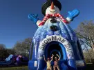 Snowman bounce house rental in Dallas with red mittens and coal details—ideal for McKinney winter parties.
