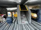 Construction-themed bounce house with gray, yellow, and slide attachment available for rental in Dallas, Plano.