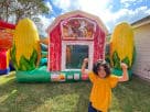Farm-themed bounce house rental in Houston with bright yellow corn décor, ideal for The Woodlands parties.