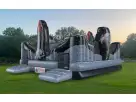 Four-kid inflatable obstacle course with climbing towers and slides available for rental in Dallas—ideal for Arlington birthday