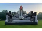 Gray and red space shuttle bounce house rental in Austin with dual slide exits, perfect for up to 4 kids at birthday parties