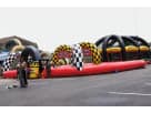 Racing-themed tricycle track inflatable rental in Dallas with dual tricycles, ideal for kids' competitive play at McKinney