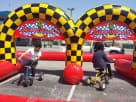 Perfect for Plano birthday parties, this race-themed tricycle rental in Dallas features two riding vehicles and checkered arch