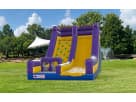 Purple and yellow inflatable rockwall and slide rental in Houston with climbing wall feature, ideal for Cypress parties.