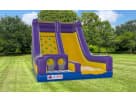 Perfect for Katy birthday parties, this purple and yellow inflatable rockwall and slide rental in Houston features dual slides