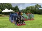 Train-themed obstacle course rental in Dallas with colorful locomotive and passenger cars, ideal for kids' parties in Mesquite.