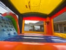 Modern rainbow bounce house with water slide rental in Austin—wet or dry inflatable combo ideal for San Marcos summer parties.