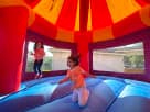 Toy Story 4 Carousel bounce house rental in Houston with children jumping—Disney-licensed moonwalk ideal for Spring birthday