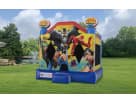 Justice League bounce house rental in Houston backyard with blue and yellow design, ideal for superhero-themed kids' parties