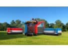 Justice League Obstacle with dual slides bounce house rental in Austin, perfect for Kyle birthday parties and events.