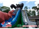 Dinosaur obstacle course rental in Austin with dual slides, ideal for ages 3 and up at backyard parties in Buda.