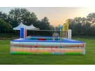 Multicolor inflatable obstacle course with slide towers available for rental in Austin, ideal for Cedar Park events and group
