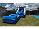 Blue water slide rental in Austin with attached pool base, climbing wall, and curved slide chute—ideal for Round Rock backyard
