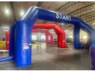 Blue and red inflatable race track arch with start and finish lines available for rental in Dallas, ideal for Irving events.