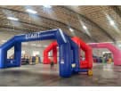 Blue and red inflatable race track arch with start and finish lines, ideal for Dallas event rentals and racing-themed parties