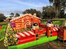 Christmas nutcracker bounce house rental in Houston with red and white candy cane stripes, ideal for all ages at Spring holiday