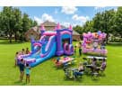 Pink and purple bounce house with dual water slides rental in Houston, perfect for Pasadena birthday parties with kids playing.