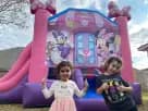 Minnie Mouse bounce house rental with dual slides in a Dallas backyard, ideal for toddler and kids' parties in McKinney.