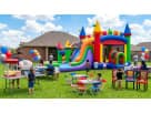 Rainbow bounce house water slide rental in Dallas with wet or dry capability, ideal for Irving backyard parties.