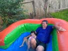 Perfect for Houston summer parties, this rainbow bounce house rental features a wet or dry water slide with vibrant colors