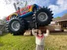 Monster truck bounce house rental in Houston with slide and climbing wall, ideal for kids' parties in The Woodlands.