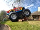Monster Truck Deluxe bounce house rental in Dallas with oversized tires and climb slide, ideal for Plano birthday parties.