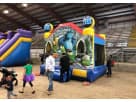 13x13 Monsters University bounce house rental in Dallas with Mike and Sulley characters, dual slides, and castle towers