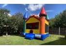 Colorful castle bounce house rental in Dallas with four turrets, ideal for Mesquite birthday parties and family events.