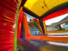 Modern rainbow wet or dry bounce house combo rental in Dallas, perfect for Mesquite summer parties with enclosed slide