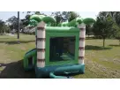 Green and purple monster bounce house rental in Austin featuring a slide entrance for Georgetown birthday celebrations.