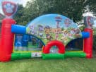 Paw Patrol toddler bounce house rental in Dallas backyard with colorful red, blue, and green sections, ideal for McKinney parties.