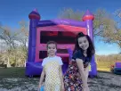 Pink Castle bounce house rental in Dallas with turret design, ideal for Garland birthday parties.