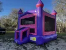 Pink Castle bounce house rental in Dallas with dual slide and turrets, ideal for McKinney birthday parties.