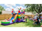 Pop Its Bounce House themed kids birthday party in backyard.